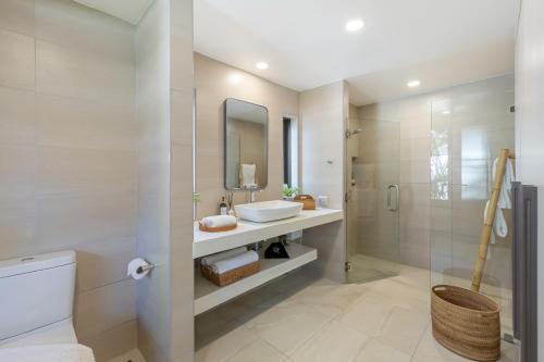 a bathroom with a sink and a toilet and a shower at Bacaya Beachfront Villa in Bang Rak Beach