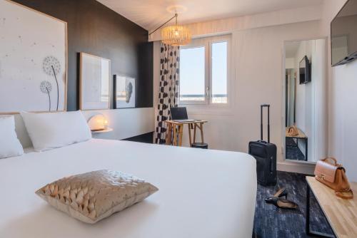 a bedroom with a large white bed and a window at ibis Styles Paris Gare de l'Est Château Landon in Paris