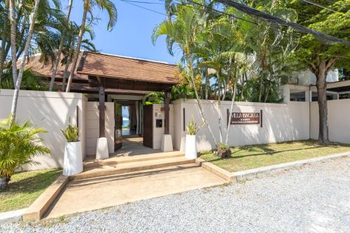 a villa with a entrance to a house at Bacaya Beachfront Villa in Bang Rak Beach