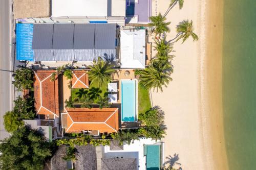 an overhead view of a house and the beach at Bacaya Beachfront Villa in Bang Rak Beach