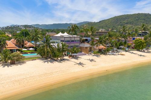 an aerial view of a resort on the beach at Bacaya Beachfront Villa in Bang Rak Beach