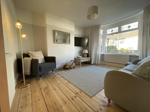 a living room with a couch and a chair at Harmonious Family Home in Westbury-on-Trym in Bristol