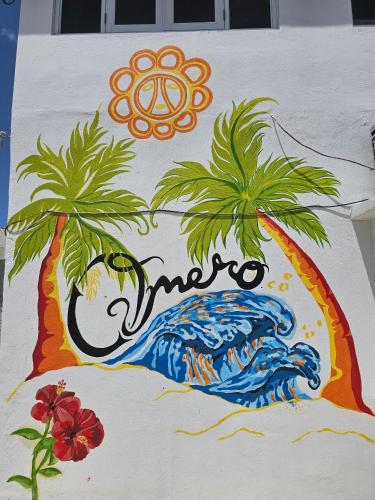 a painting of two palm trees on a wall at OMERO Ocean Park in San Juan