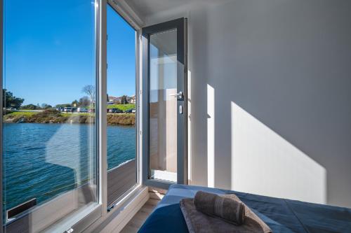 a room with a large window with a view of the water at Floating house - ARIA in Pula