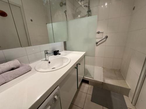Un baño blanco con lavabo y ducha. en 100 m T3 with loggia - Eurexpo-Groupama Stadium, en Saint-Priest