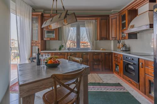 a kitchen with a table with a bowl of fruit on it at Avgerinos in Makrochórion