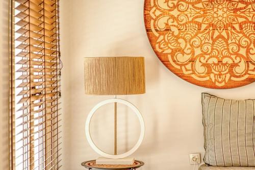 a lamp on a table next to a mirror at Santa Maria Hotel in Elia Beach