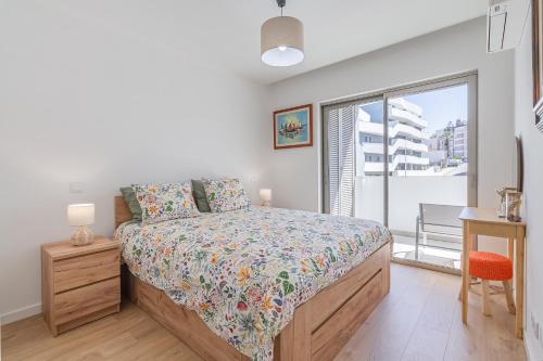 a bedroom with a bed and a window at Don Tenorio Chic Apartment in Lagos