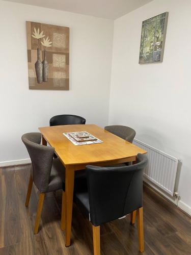 a dining room table and chairs in a room at Pure Home Rosyth Dockyard By Tba in Rosyth