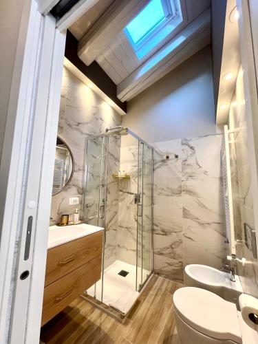 a bathroom with a shower and a toilet and a sink at Vanessa Home in Burano