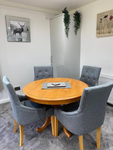 a conference room with a wooden table and chairs at Super Prime Abbey Free Parking By Tba in Dunfermline