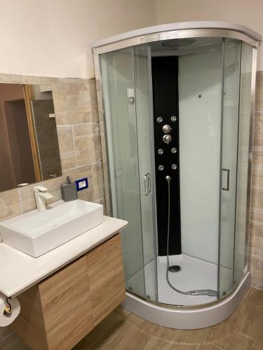 a bathroom with a sink and a shower at villa Ada apartment in Cercivento