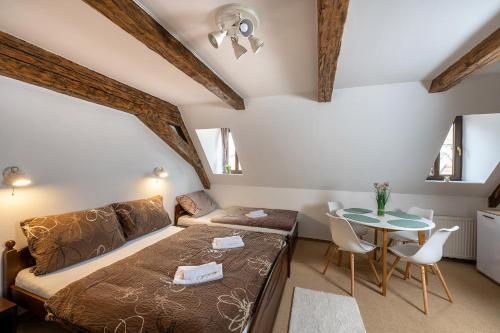 a bedroom with a bed and a table at Rodinný hotel Myslivna in Třeboň