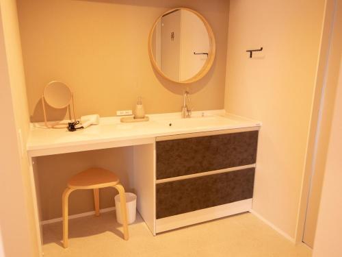a bathroom with a sink and a mirror at Aso La Vista 阿蘇の家 in Aso