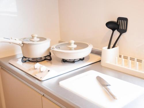 a kitchen counter with a slow cooker on a counter top at Aso La Vista 阿蘇の家 in Aso