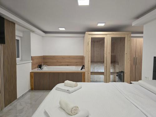 a bedroom with two beds and a bath tub at Wellness Deluxe Edy Room in Zagreb