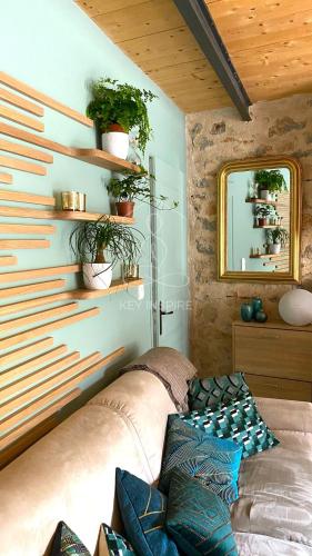 un salon avec un canapé et un miroir dans l'établissement La Petite Maison d'Emmanuelle, à Le Tignet