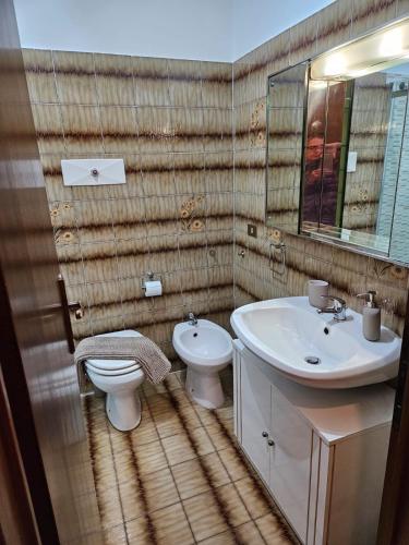 a bathroom with a sink and a toilet and a mirror at BellaVista in Ranzanico
