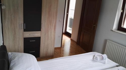 a bedroom with a bed and a dresser with a mirror at Apartment Šija in Bohinj