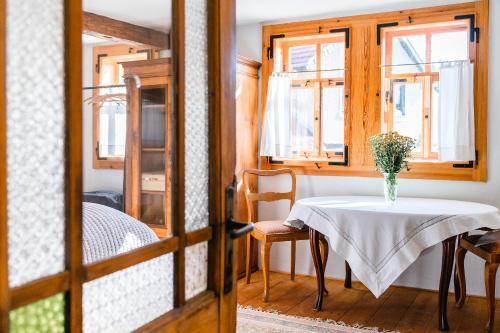a table with a vase on it in a room at Landhaus Fröbel in Bad Liebenstein