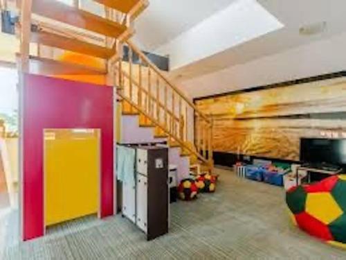 a room with a staircase and a playroom with toys at Willa KF2 in Łeba