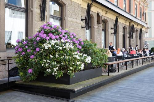 a planter with flowers on a bench outside a building at Hotel Central in Innsbruck