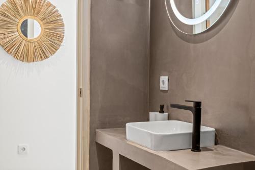 a bathroom with a white sink and a mirror at SERU40 Apartment 1 in Willemstad