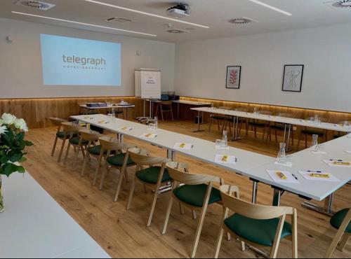a conference room with a long table and chairs at Hotel Telegraph in Oberwart