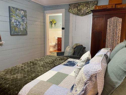 a bedroom with a bed with a quilt on it at Yellow Daisy Bed and Breakfast in Dahlonega