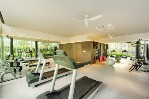 a gym with treadmills and exercise equipment in a room at Naman Retreat in Da Nang