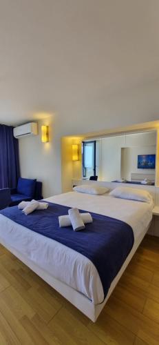 a large bed in a hotel room with two pillows at Beachfront Apartaments in Orbi City in Batumi