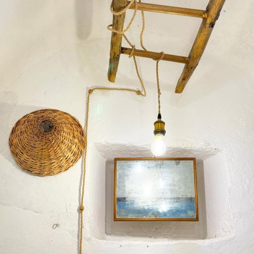 a picture and a light hanging from a wall at Vista Lago - Lake Como collection in Domaso