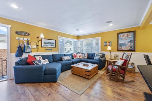 a living room with a blue couch and a table at 315E Upper 315 Eucalyptus Upper in Avalon