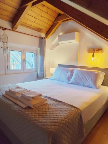 a bedroom with a large bed with two towels on it at Homeric Poems in Argostoli