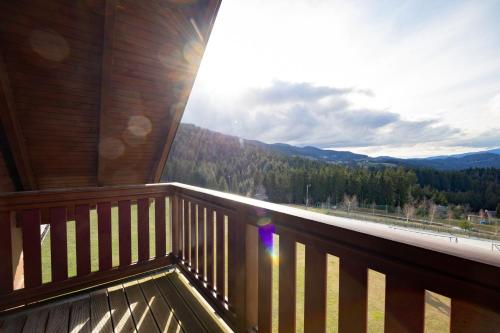 a balcony of a cabin with a view of the mountains at Apartmaji Bar Smučar in Ribnica na Pohorju