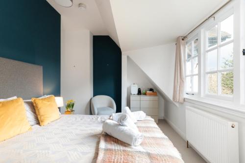 a bedroom with a large bed and a window at The Vicarage Tooting, SW17 in London