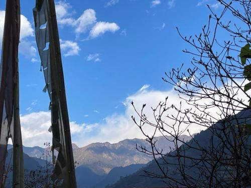 a view of a mountain range from a window at Daragaon Retreat (Gurung Homestay) in Pelling