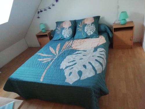 une chambre avec un lit avec une couette bleue dans l'établissement La MAISON DU PECHEUR, à Barfleur