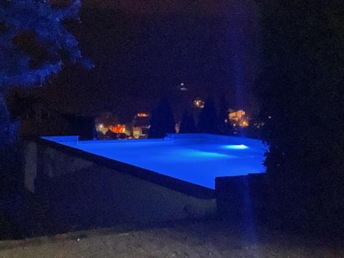 a swimming pool at night with blue lights at Willa Świerkowa 19 in Szczyrk