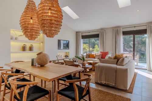 a living room with a table and chairs at Boutique Hotel Los Limoneros in Moraira
