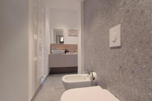 a bathroom with a white toilet and a sink at Cà del Lasco - Free parking apartments 5 min from the station in Bellano