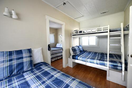 two beds in a room with two bunk beds at 319CE 319 Clemente in Avalon