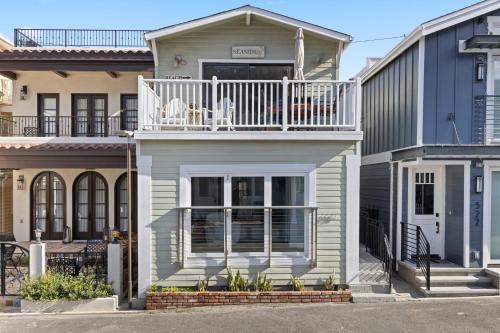 a house with a balcony on top of it at 320E 320 Eucalyptus in Avalon