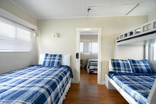 a bedroom with two beds and a bunk bed at 319CE 319 Clemente in Avalon