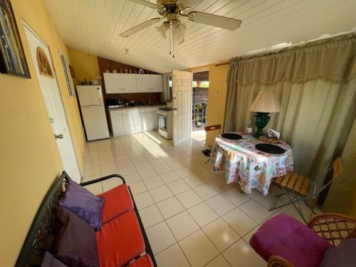 a living room with a table and a kitchen at Paradise Apartment in Palm-Eagle Beach