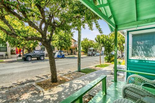 a green house with a bench and a tree on a street at 322S 322 Sumner Ave in Avalon
