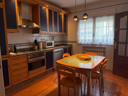 a kitchen with a table with a cake on it at Apartamento Puerto De Llanes VUT-138-AS in Llanes