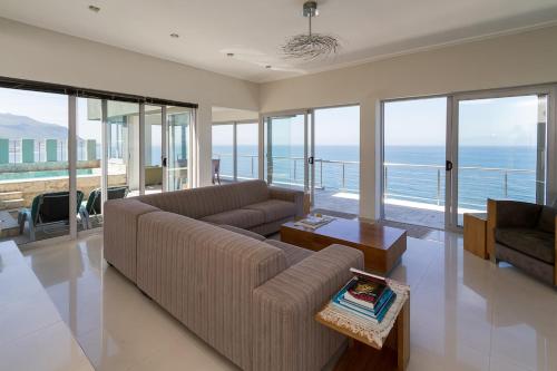 a living room with a couch and a table at Sea Views Oceans Echo Villa in Fish Hoek