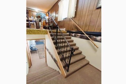 a spiral staircase in a home with wooden walls at Love Hotels Voyageur by OYO at International Falls MN in International Falls