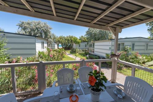 a patio with a table and chairs on a balcony at Club del Sole Stork Family Collection in Giulianova